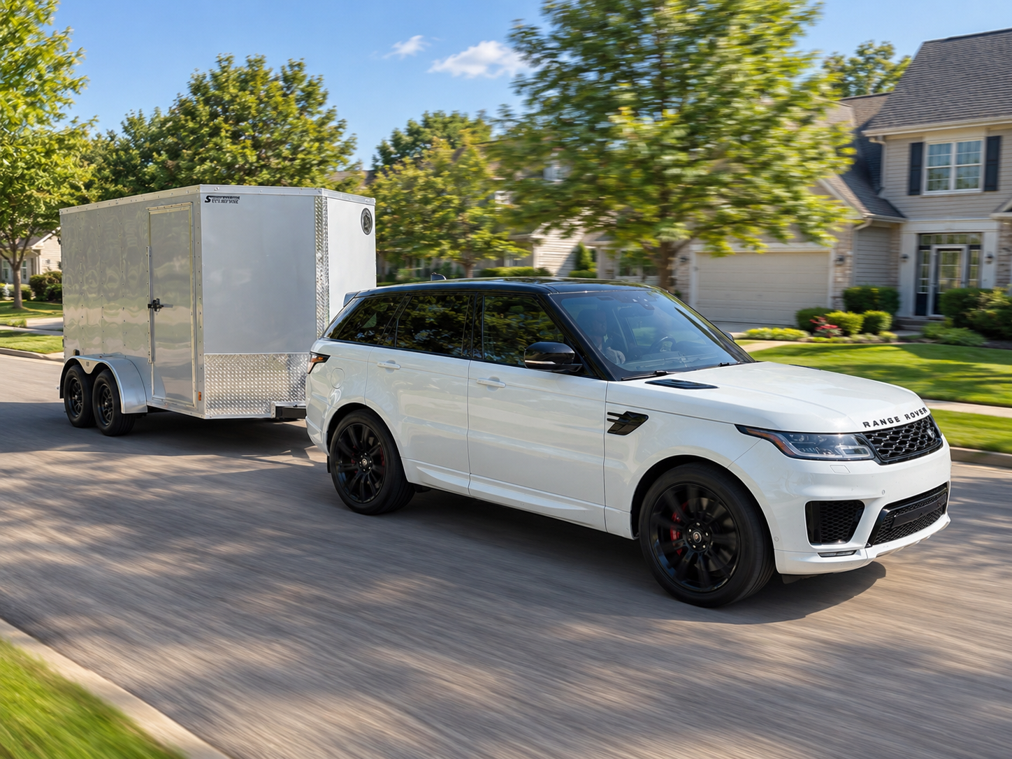 SUV towing a Simply Hitched enclosed cargo trailer through a residential neighborhood